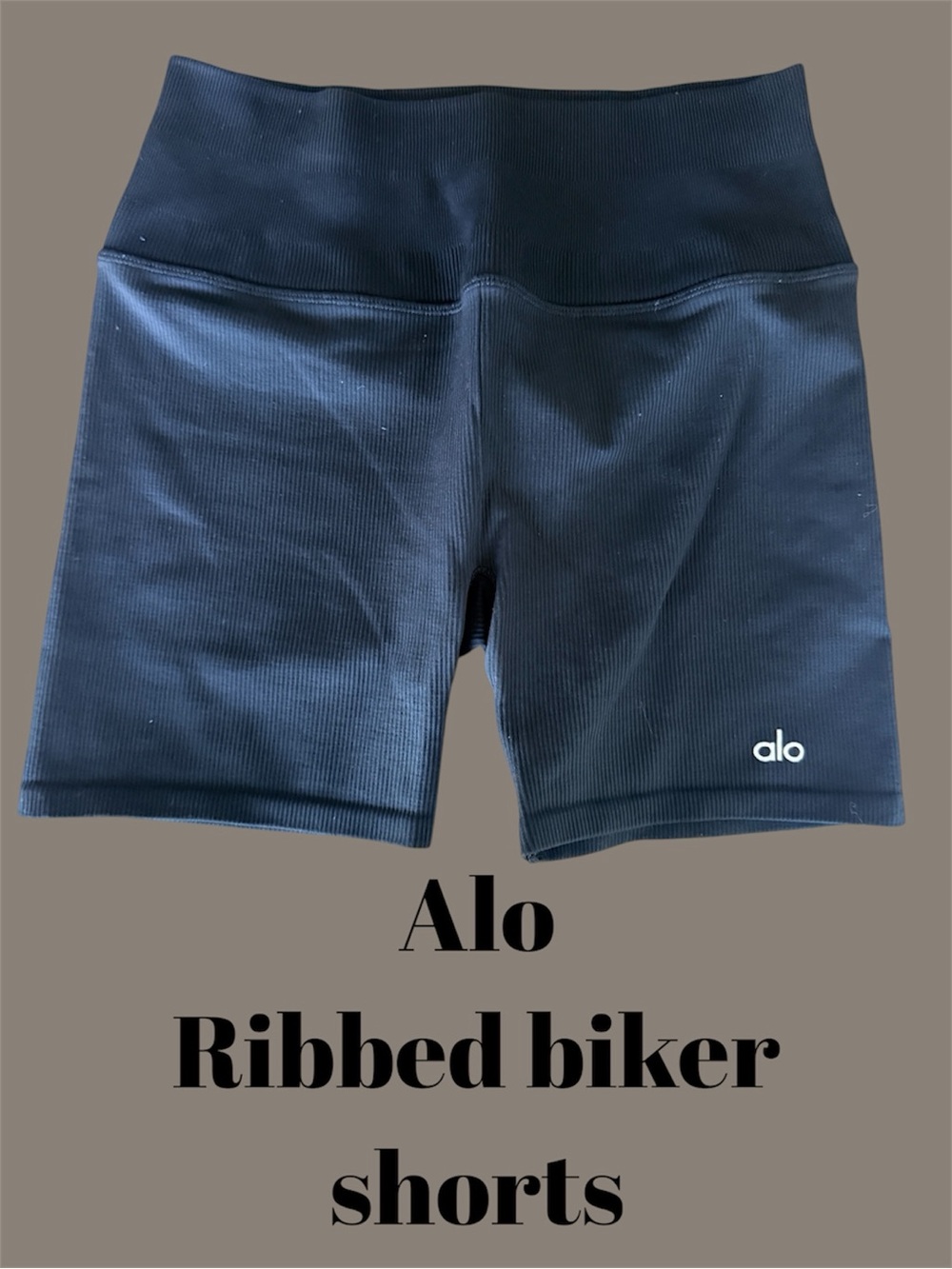 Authentic Alo Yoga high-rise ribbed biker shorts in Black.